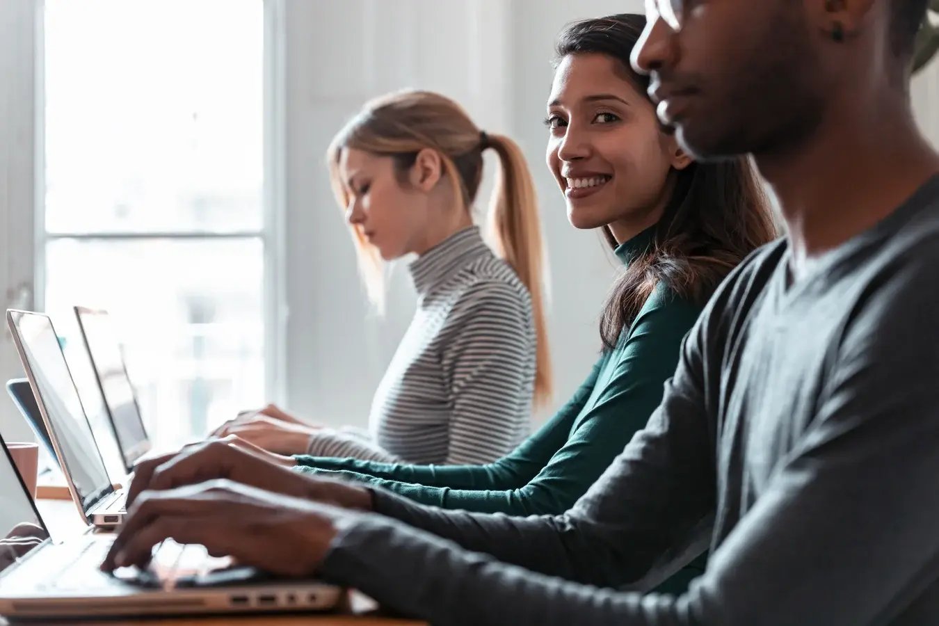 businesswoman-working-with-laptop-between-other-co-2024-09-12-18-22-02-utc