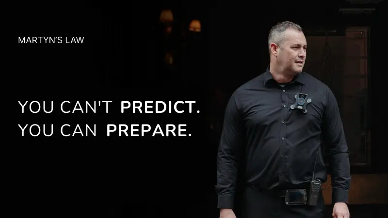 A man wearing a black shirt with text overlay that reads 